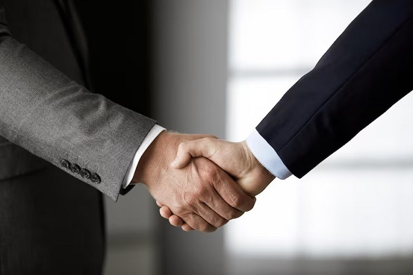 business-people-office-suits-standing-shaking-hands-close-up-business-communication-concept-handshake-marketing